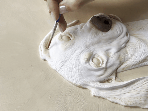 Hand-sculpting the 3D relief portrait